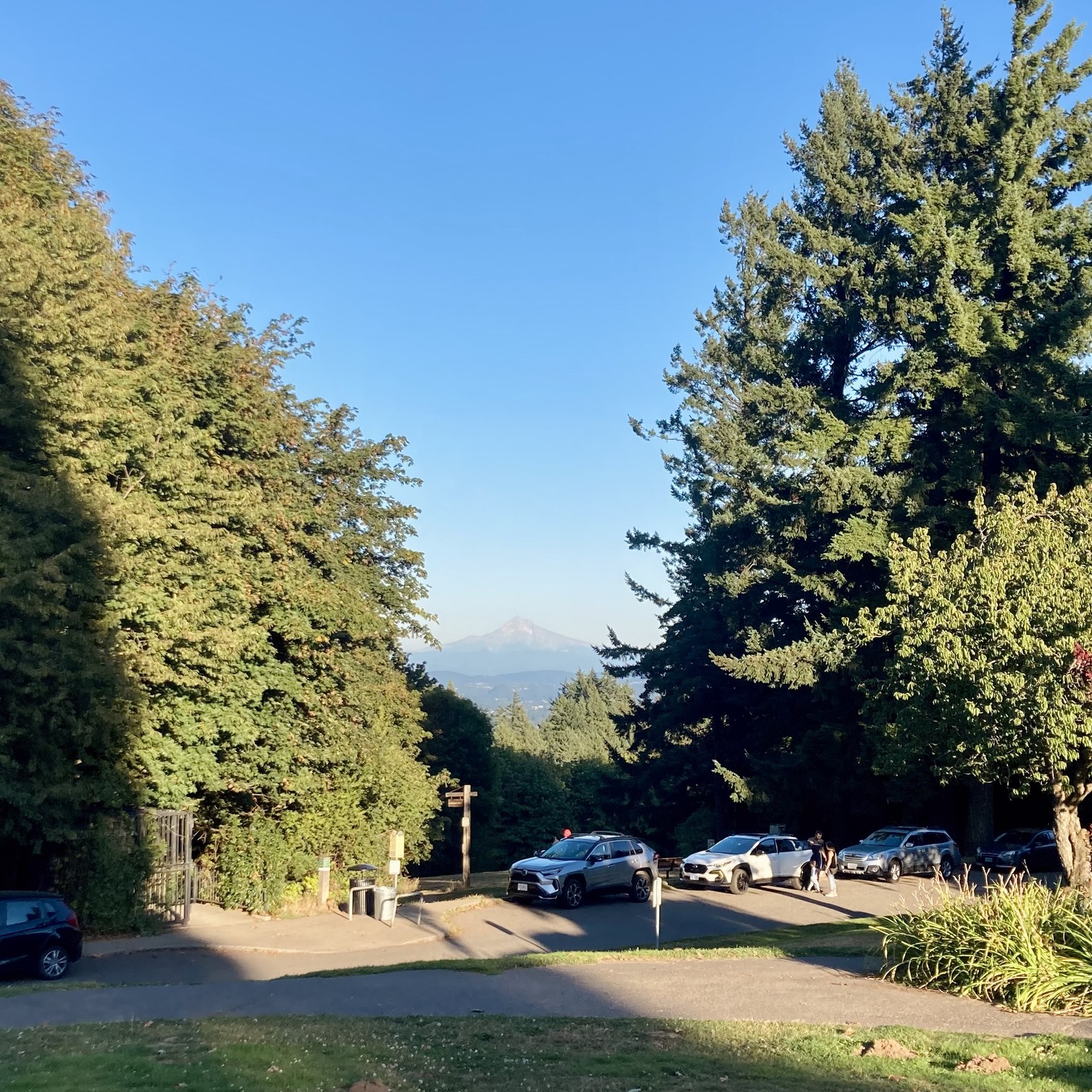 Barely any snow on the mountain in the waning days of summer. Long shadows. Clear sky.