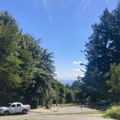 A few small low clouds (from the “marine layer”) cling to the foot of Mt. Hood on an otherwise clear summer morning