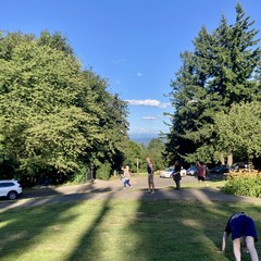 Mountain visible about 2hrs before sunset on a perfect July evening. Lots of people walking through the foreground. A young woman in the foreground doing downward dog oblivious to the fact that like 5 people are trying to take pictures of the mountain