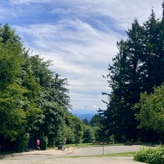 Mt. Hood wreathed in clouds under an otherwise sunny sky